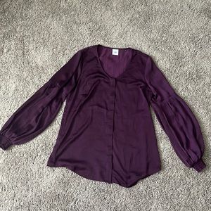 Plum color Cabi blouse with bubble sleeves.